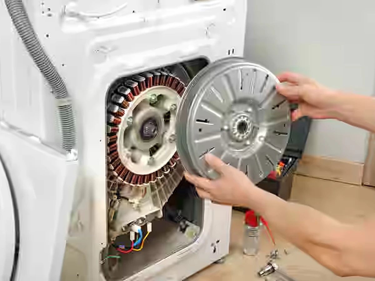 Technician inspecting the pump filter of a Bosch front load washing machine